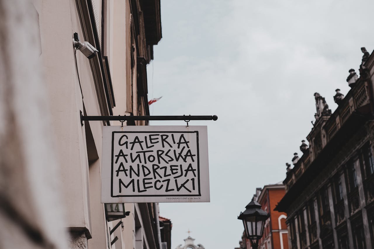 Art gallery sign in historic Kraków Old Town, reflecting the citys rich culture.