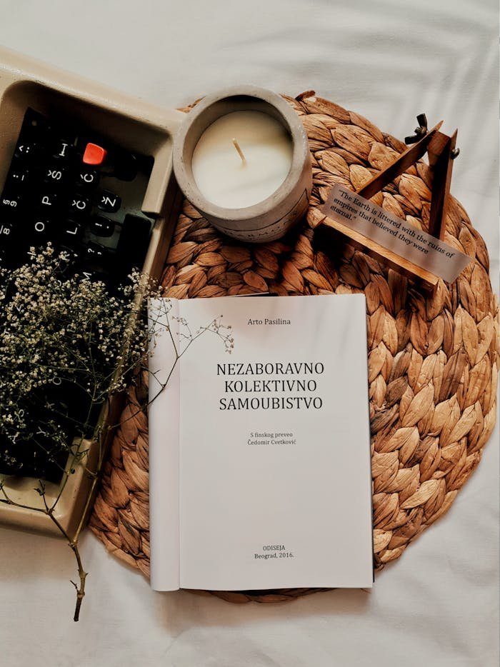 Cozy still life with a book, candle, and rustic decor elements.